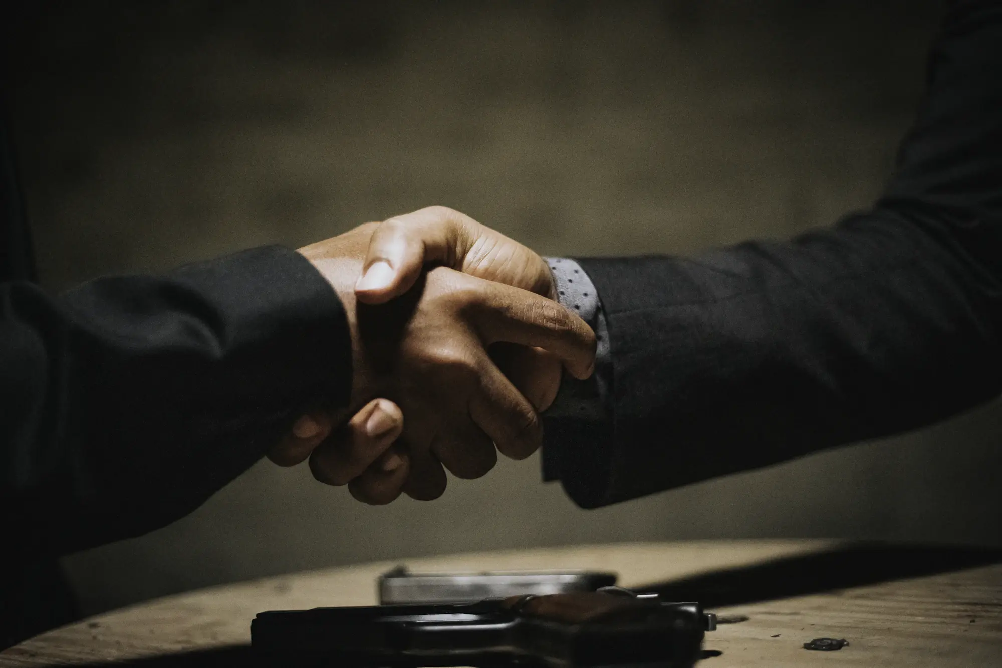 A lawyer and client shaking hands across a desk